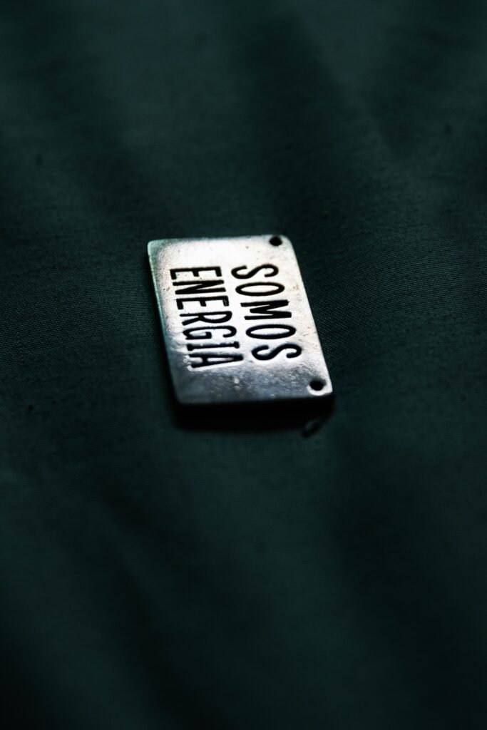 A close up of a metal tag on a black surface